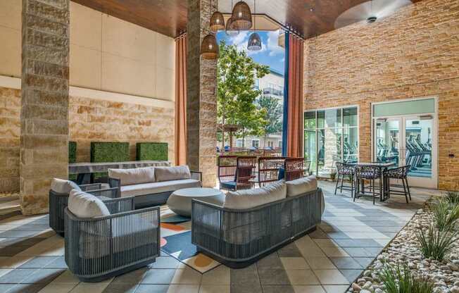 the lobby of a hotel with couches and chairs and a table