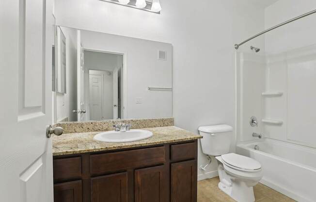 A white toilet sits next to a sink in a bathroom.