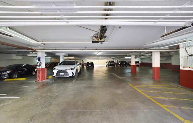 A parking garage with parked vehicles.