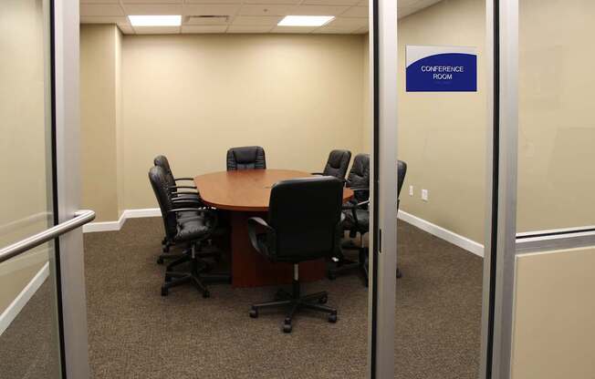 A conference room with a table and chairs.