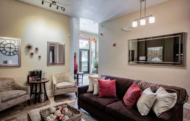 a living room with a couch chairs and a coffee table At Metropolitan Apartments in Little Rock, AR