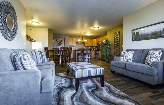 a living room and dining room with couches and a table