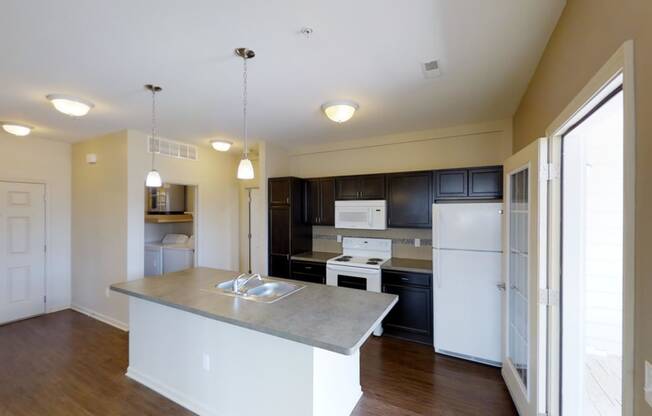 a kitchen with white appliances and black cabinets