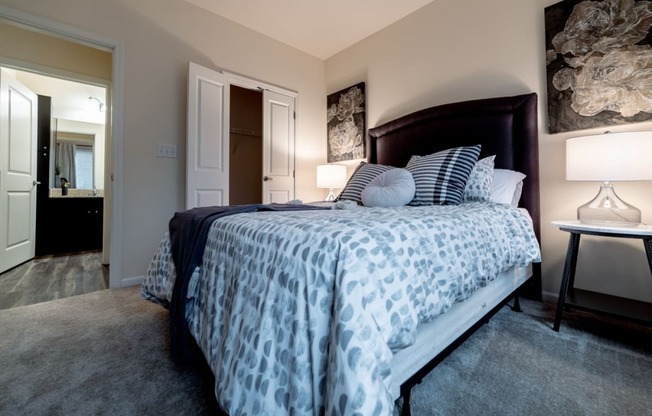a bedroom with a large bed and a bathroom at 310 at Nulu Apartments-Student, Louisville, KY