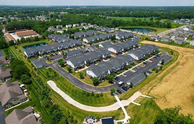A bird's eye view of a residential area with houses and a playground.