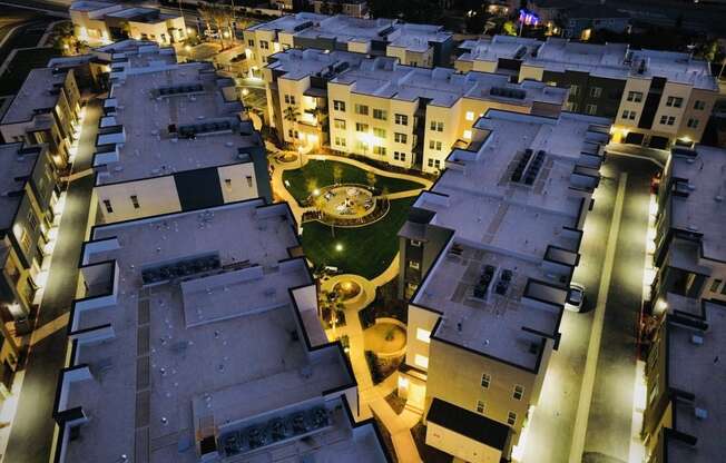 a city at night with buildings and a fountainat Westbury Apartments, Rancho Cucamonga, CA, 91739