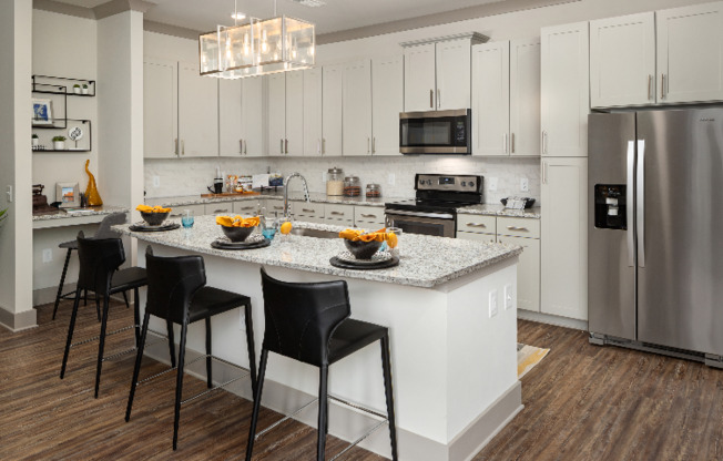 Model kitchen at our apartments for rent in Atlanta, featuring granite countertops and a kitchen island.