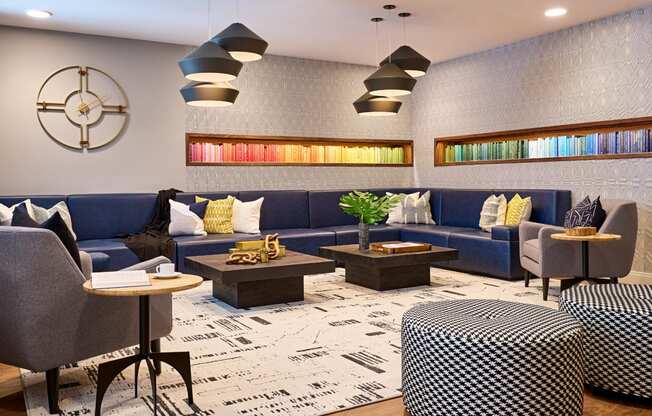 a lobby with blue couches and tables and a clock on the wall at Dey & Bergen, Harrison, 07029