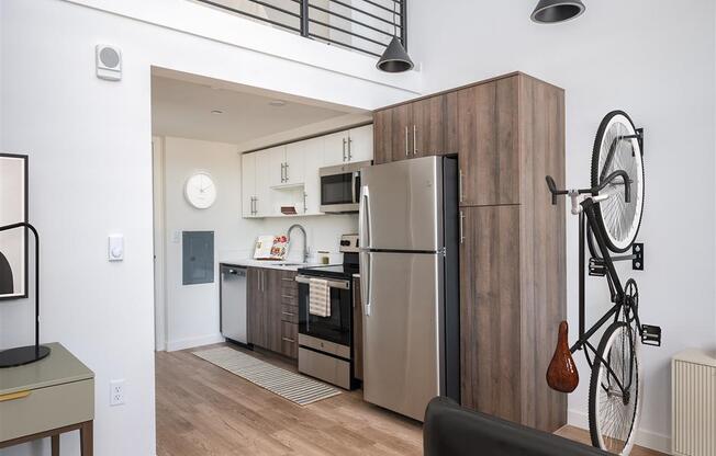 a kitchen with stainless steel appliances and a bike on the wall