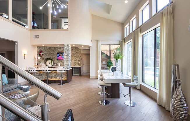 A modern living room with a stone wall and a staircase.