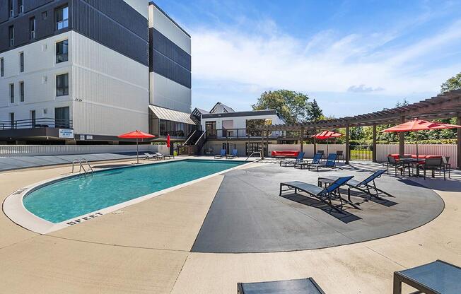 our apartments have a large pool and lounge chairs at Troy Place Apartments - Troy, MI, Troy, 48084