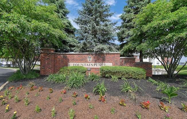 a brick retaining wall with a sign that says flintstone place