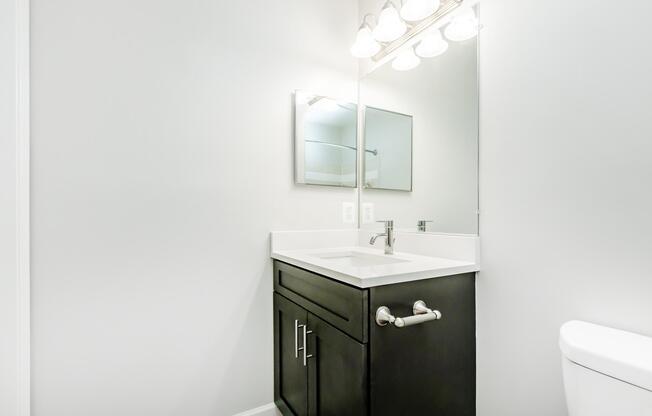 a room with a sink and a mirror