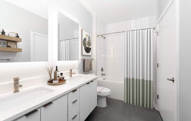 A white bathroom with a toilet, sink, and shower.