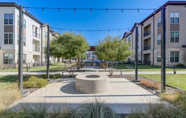 an outdoor area with trees and a fire pit