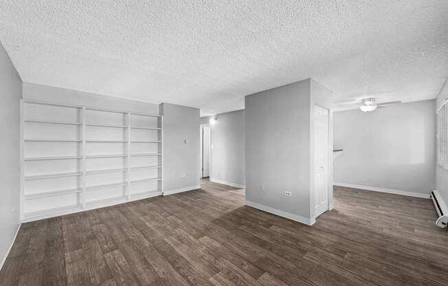 A room with a wooden floor and white walls.