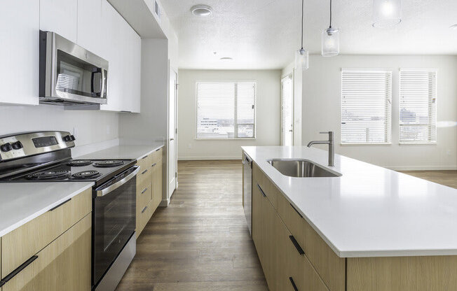 a kitchen with a floating island counter at Lotus Republic Apartments for rent in Downtown Salt Lake City, Utah