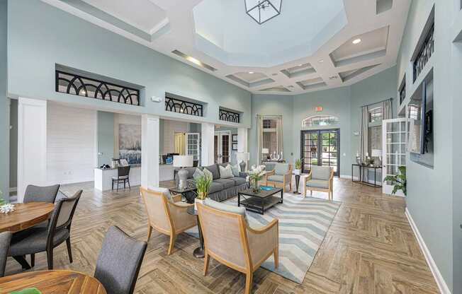 a large living room with chairs and couches
