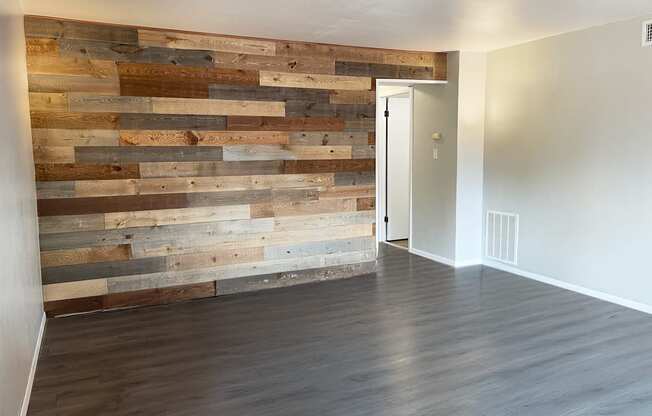 living room with wood accent wall at Shiloh Commons Apartments