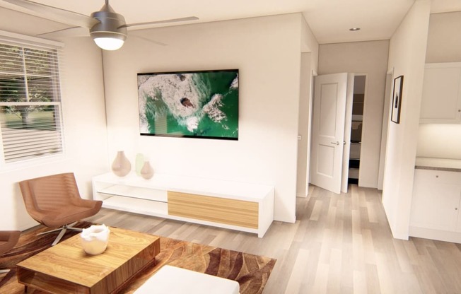 a living room with hardwood floors and white walls at Brownstones at Palisade Park, Broomfield