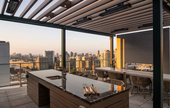 a terrace with a table and chairs and a view of a city