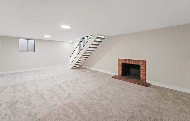 A room with a fireplace and a staircase.