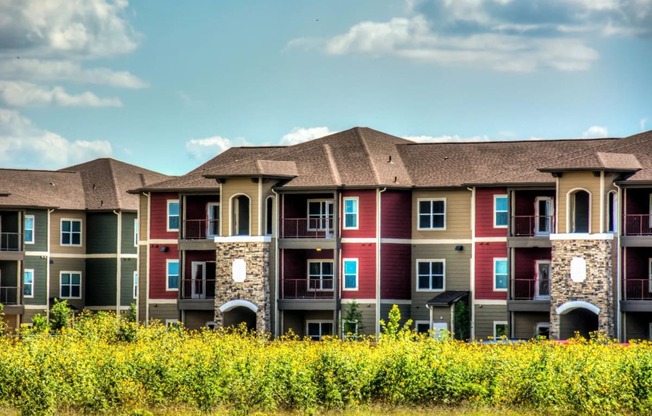 a row of apartment buildings with blue sky in the background at Villa Espada Apartments, San Antonio, TX