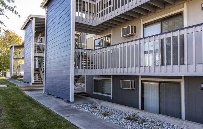 Exterior view of rock path and buildings at The Lakes Apartments, Moses Lake, WA.
