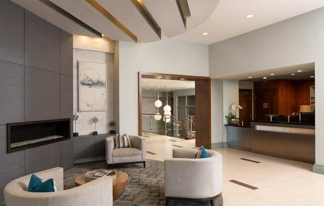 a living room with couches and chairs and a fireplace