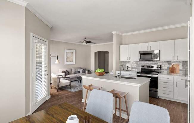 A kitchen with a white countertop and a white ceiling fan.