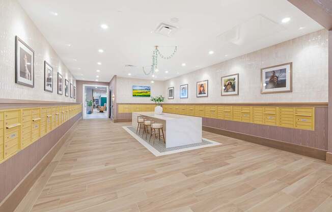 A long hallway with a white counter in the middle and pictures on the wall.