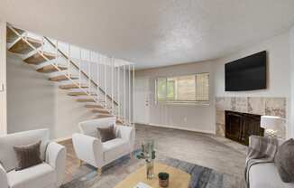 a living room with white furniture and a staircase and a tv