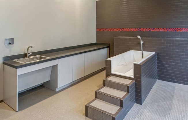 a bathroom with a sink and a bath tub and a counter with two sinks