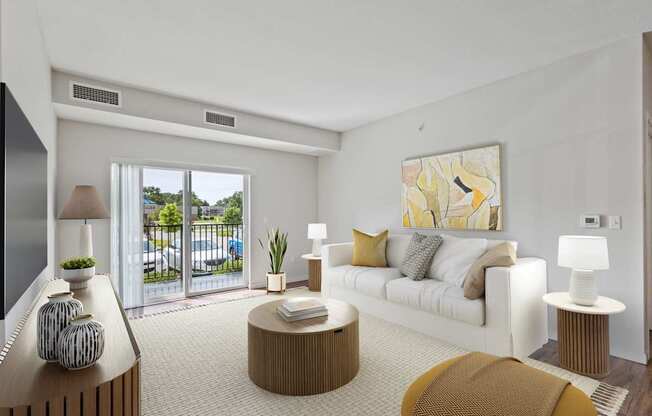 A living room with a white couch, a brown coffee table, and a large painting on the wall.