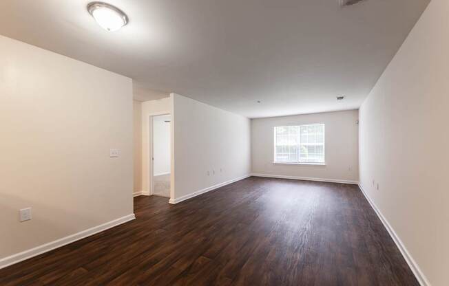 A room with wooden floors and a window.
