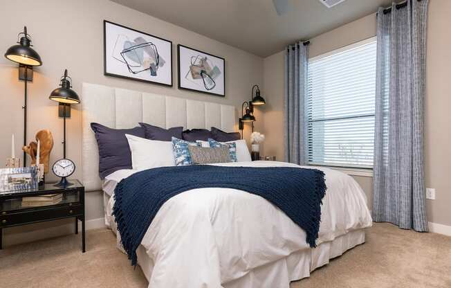 Bedroom with a Made Bed at Escape at Arrowhead Apartments