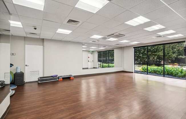 Community Exercise Room with Mirrors and Fitness Equipment at Mason Van Dorn Apartments located in Alexandria, VA.