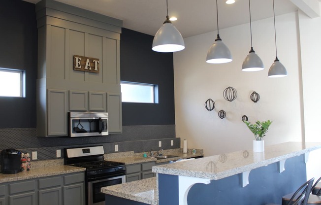 a kitchen with a counter top and a stove
