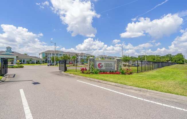 entrance to apartment community with sign and gate