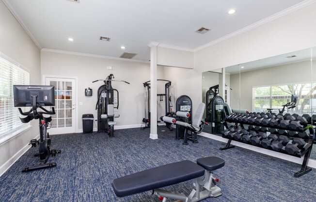 a gym with cardio equipment and exercise machines