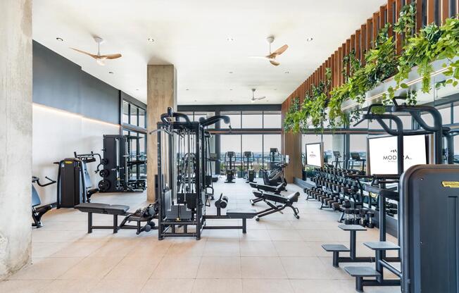 Stay active in the expansive fitness center at Modera St. Paul, offering cutting-edge equipment and inspiring views of downtown Dallas.