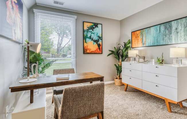 a home office with a desk and a dresser at The View Apartments St Charles, St Charles, IL