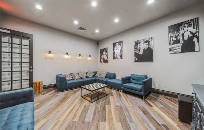 a living room with blue couches and a coffee table