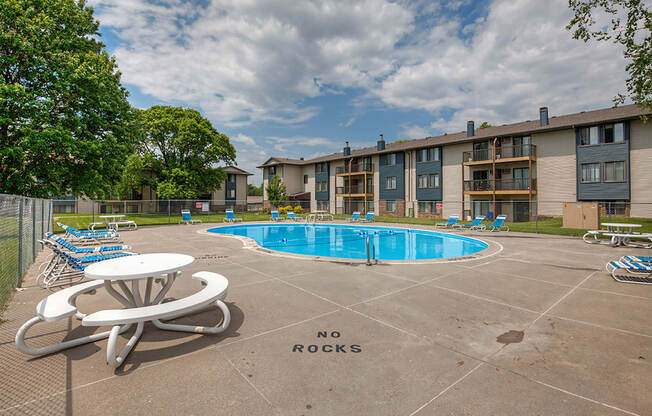 our apartments have a resort style pool with chairs and tables