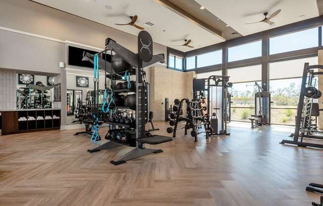 A gym with a variety of equipment including weights and machines.