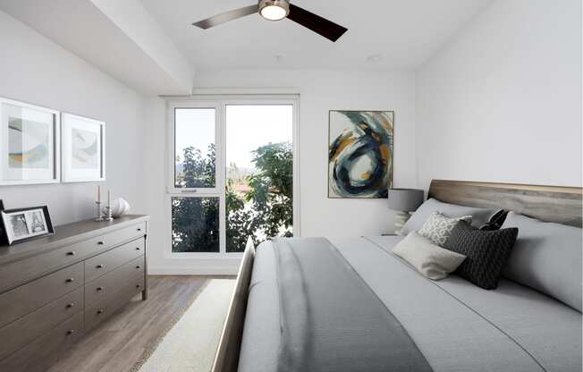 a bedroom with a large bed and a ceiling fan