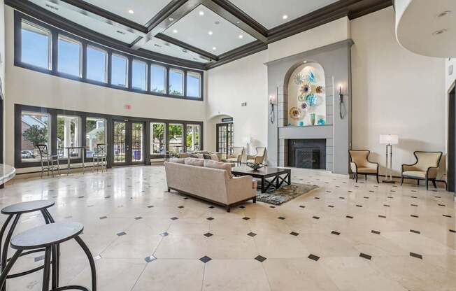 A spacious living room with a fireplace and a large window.