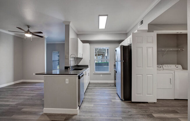 a kitchen with a stove top oven next to a refrigerator