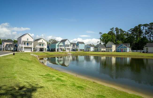 a pond in front of a row of houses