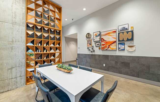 a dining room with a white table and chairs